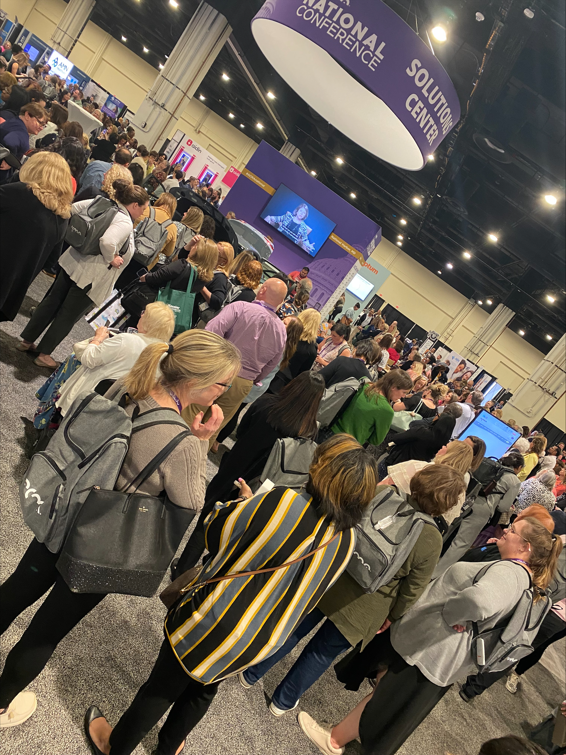 A large group of people gather for the Win the Wheels Giveaway